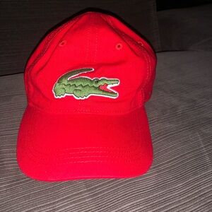 A red Lacoste baseball cap.